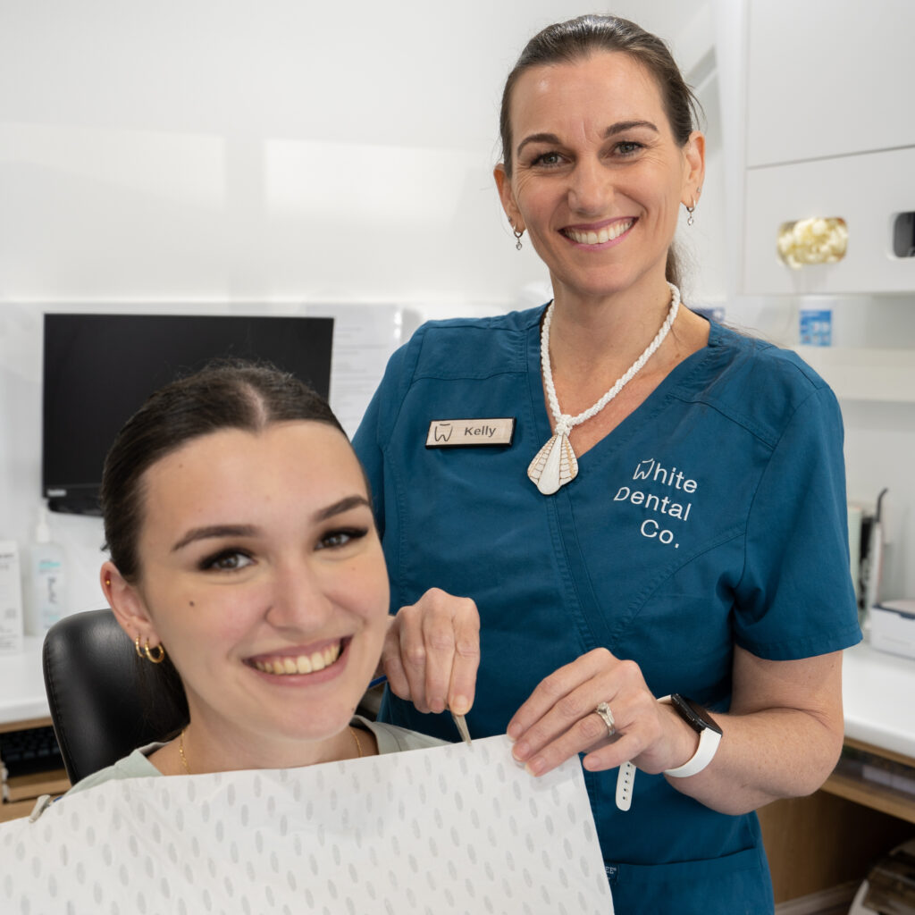 A smile from a young patient and dental assistant, Kelly, at the beginning of an appointment.