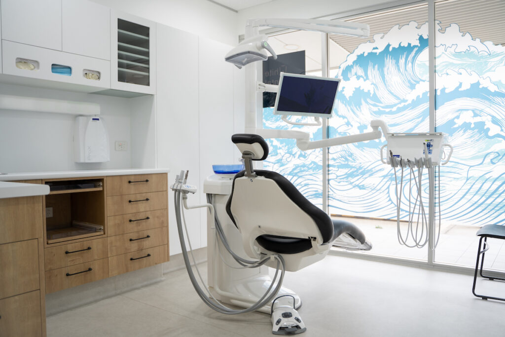 A dental chair in one of White Dental Co.'s treatment rooms. The chair and surrounding equipment are modern, and the decor is calming and reassuring.