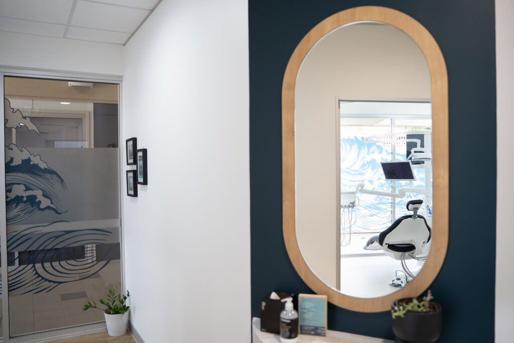 The interior of White Dental Co. reveals beautiful relaxing decor with accents of navy and gold.