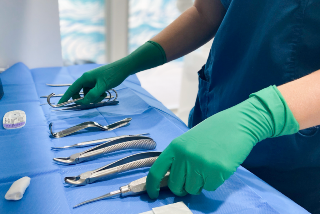 A dental assistant prepares sterile instruments ready for a surgical procedure in the rooms of White Dental Co.