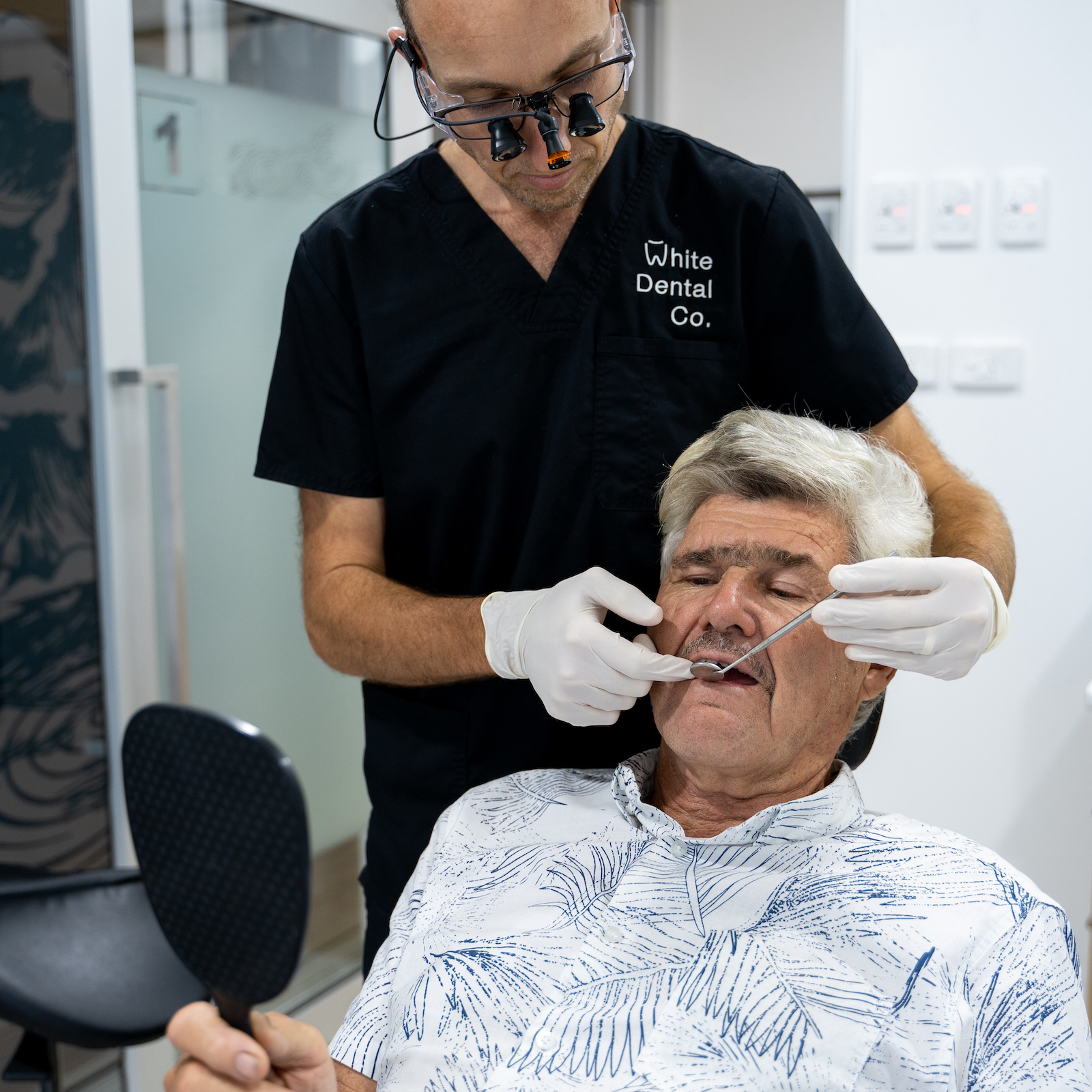 A smile from a young patient and dental assistant, Kelly, at the beginning of an appointment.