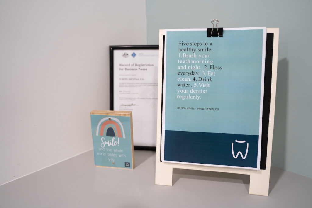 A poster about Preventive Dentistry sits on an easel on a shelf at White Dental Co.
