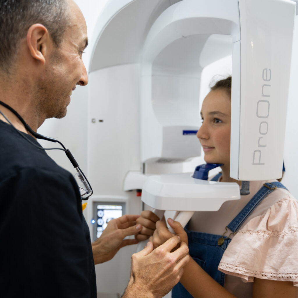 Dr Nick White prepares a patient for an OPG, a type of dental x-ray often used to screen for impacted wisdom teeth