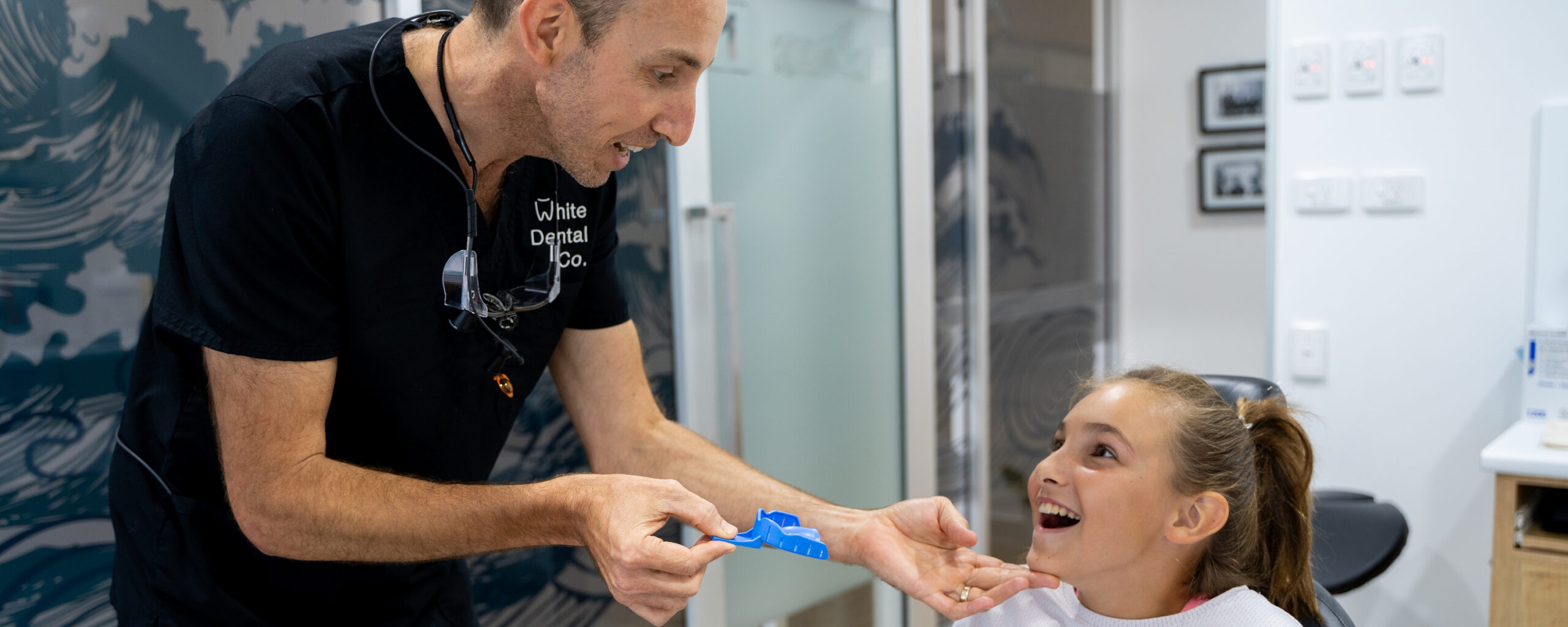 Dr Nick prepares a young patient for an impression for a mouthguard. He is holding an impression tray, ready to try it in to check it’s the correct size.